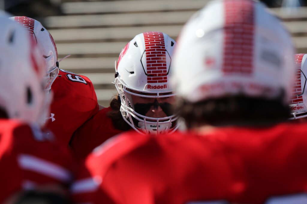 Grove City Men's Football linemen in a huddle